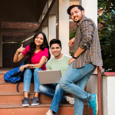 young-asian-indian-college-students-reading-books-studying-laptop-preparing-exam-working-group-project-while-sitting-grass-staircase-steps-college-campus_466689-7693